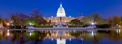 Panorama of the US Capitol Building with its Reflection on Water at Night